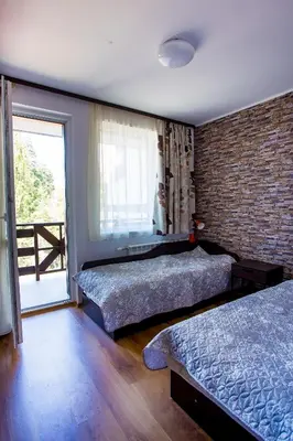 a bedroom with two beds and a brick wall at Apartment IVA - Iglika 2 in Borovets