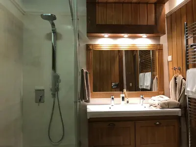 a bathroom with a shower and a sink and a shower at Pirin Golf and Spa Luxury Chalet in Bansko