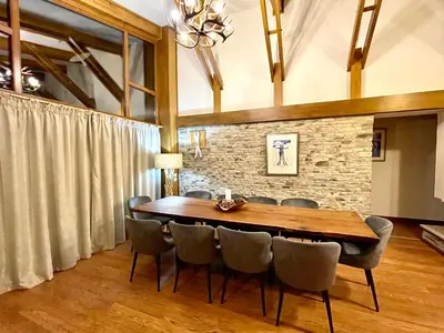 a dining room with a wooden table and chairs at Pirin Golf and Spa Luxury Chalet in Bansko
