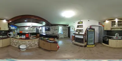 a large room with a kitchen with a fireplace at Къща за гости Суни Транс in Smolyan