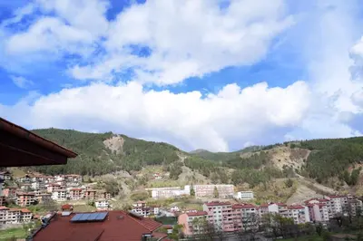 a view of a city with buildings and mountains at СТАИ ЗА ГОСТИ МЗ-ДЕВИН in Devin