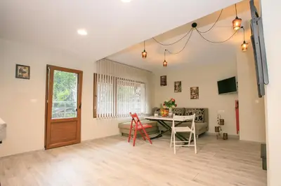 a living room with a table and a couch at Апартаменти Принц и Принцеса in Sandanski