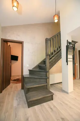 a staircase in a room with a wooden floor at Апартаменти Принц и Принцеса in Sandanski