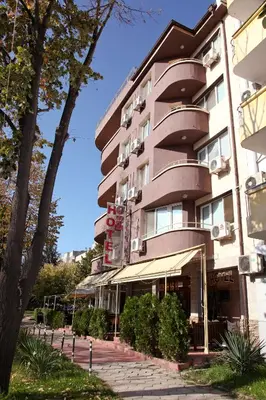 a tall building with a sidewalk in front of it at Rio Family Hotel in Blagoevgrad