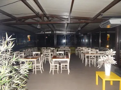 a dining room with white tables and white chairs at Rio Family Hotel in Blagoevgrad