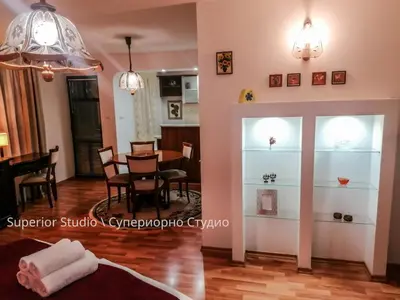 a living room with a table and a dining room at Petkov Family Hotel in Blagoevgrad