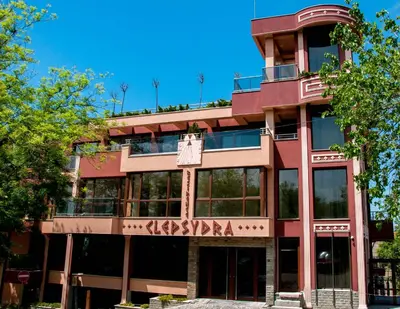 a red building with a basketball sign on it at Clepsydra Residence in Plovdiv