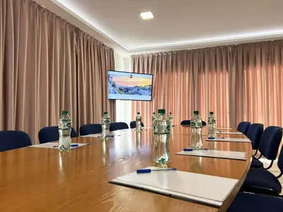 a conference room with a large wooden table and chairs at Clepsydra Residence in Plovdiv