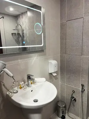 a bathroom with a white sink and a mirror at Clepsydra Residence in Plovdiv