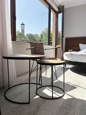 a bedroom with a bed and a table and a chair at Clepsydra Residence in Plovdiv