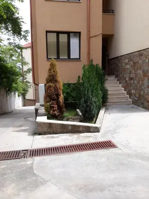 a house with a lot of plants in front of it at Апартамент ТЕА in Sandanski