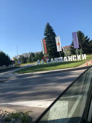 a car driving down a road with a sign on the side at Апартамент ТЕА in Sandanski
