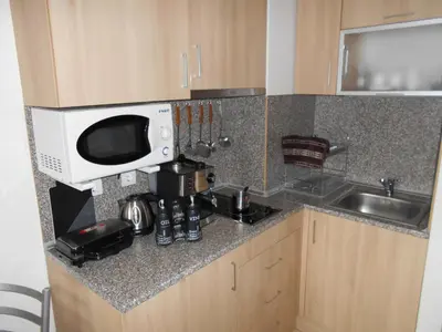 a kitchen counter with a microwave and a sink at NICE STUDIO in 