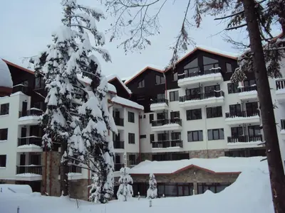 an apartment building in the snow with a tree at NICE STUDIO in 