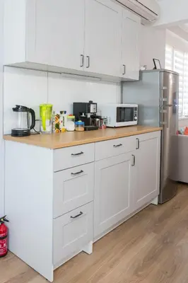 a kitchen with white cabinets and a stainless steel refrigerator at Bright and Cozy 2BD Flat in Plovdiv City Centre by Flat Mаnager in Plovdiv