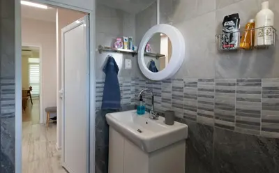 a bathroom with a sink and a mirror at Bright and Cozy 2BD Flat in Plovdiv City Centre by Flat Mаnager in Plovdiv