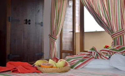 a basket of fruit sitting on top of a bed at The Poppies House in Pamporovo