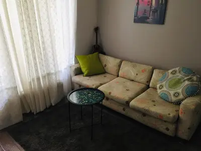 a living room with a couch and a table at Apartment Button in downtown in Sofia