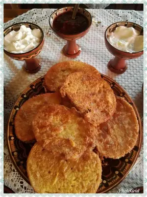 a plate of food with biscuits on a table at Радкината къща in Koprivshtitsa