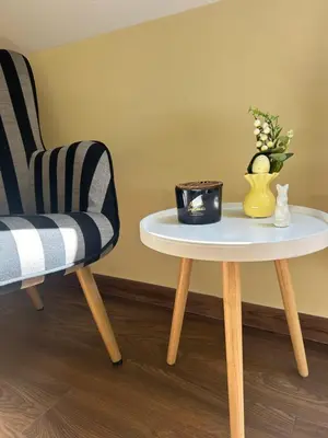 two chairs and a table with a vase on it at Roma Apartment in Sandanski
