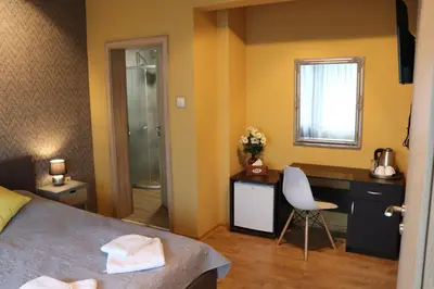 a bedroom with a bed and a desk and a chair at Urban House in Sofia