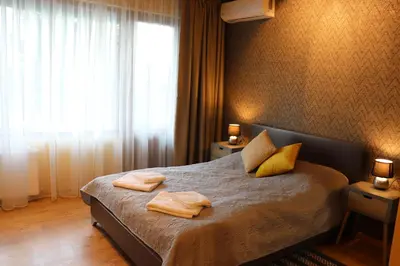 a bedroom with a bed with two towels on it at Urban House in Sofia
