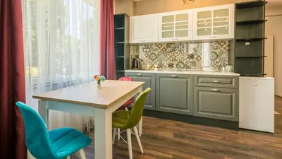 a kitchen with a table and some chairs at The old Bakery Apartments in Plovdiv