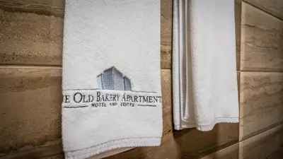 a towel hanging on a wall with a window at The old Bakery Apartments in Plovdiv