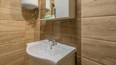 a bathroom with a white sink and a mirror at The old Bakery Apartments in Plovdiv