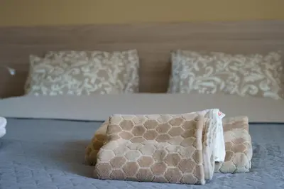 a bed with a pillow sitting on top of it at The Place -Apartments in Plovdiv, with private parking in Plovdiv