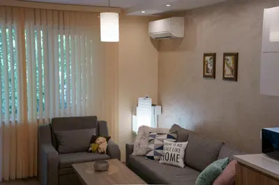 a living room with a couch and a chair at The Place -Apartments in Plovdiv, with private parking in Plovdiv