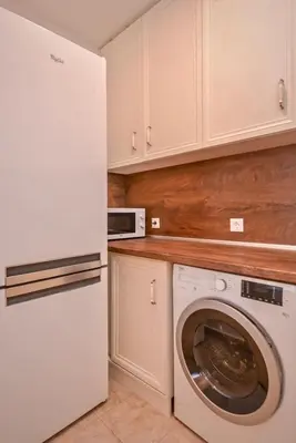 a kitchen with a white refrigerator and a washing machine at South Park, Vitosha View, 2-BDR, 2-BTHR Apartment by Flat Mаnager in Sofia