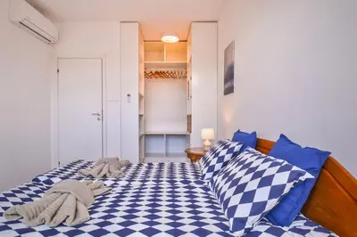 a bedroom with a bed with blue and white checkered sheets at South Park, Vitosha View, 2-BDR, 2-BTHR Apartment by Flat Mаnager in Sofia