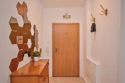 a hallway with a wooden door and a wooden dresser at South Park, Vitosha View, 2-BDR, 2-BTHR Apartment by Flat Mаnager in Sofia