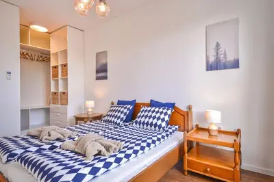 a bedroom with a blue and white checkered bed at South Park, Vitosha View, 2-BDR, 2-BTHR Apartment by Flat Mаnager in Sofia