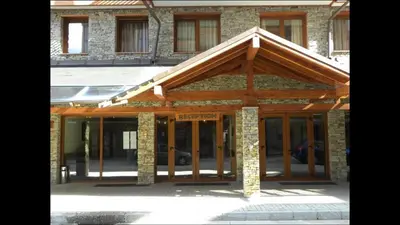 a building with awning on the front of it at Private Apartment Maxim in Bansko