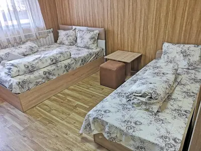 a room with two beds and a table at Bali Petrich in Petrich