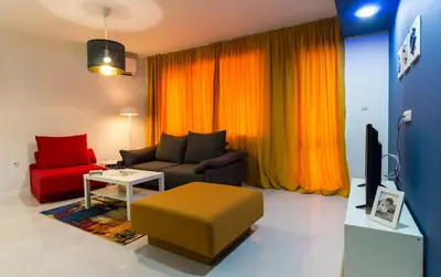 a living room with a couch and a table at Pop your COLORS - Funky and Modern 1BDR Apt by Flat Mаnager in Plovdiv