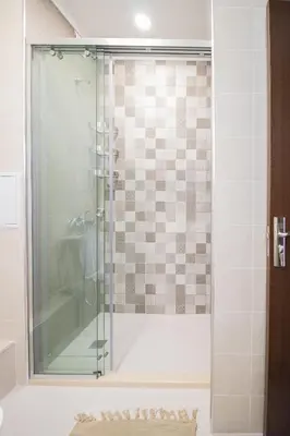 a shower with a glass door in a bathroom at Pop your COLORS - Funky and Modern 1BDR Apt by Flat Mаnager in Plovdiv