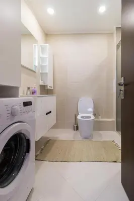 a bathroom with a washing machine and a toilet at Pop your COLORS - Funky and Modern 1BDR Apt by Flat Mаnager in Plovdiv