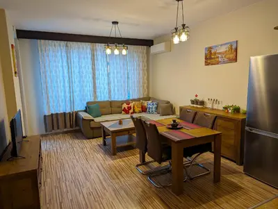 a living room with a couch and a table at Business and Leisure apartments in Mladost 2 with FREE Garage in Sofia