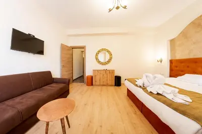 a hotel room with a couch and a bed at Sofia Crown Life Apartment in Sofia