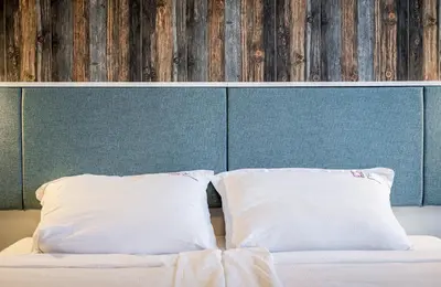 a bed with two pillows on top of it at Sofia Artist Life Apartment in Sofia