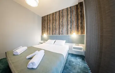 a hotel room with a bed with towels on it at Sofia Artist Life Apartment in Sofia