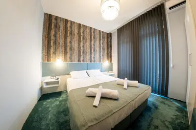 a hotel room with a bed with two towels on it at Sofia Artist Life Apartment in Sofia