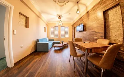 a living room with a wooden table and chairs at Sofia Artist Life Apartment in Sofia