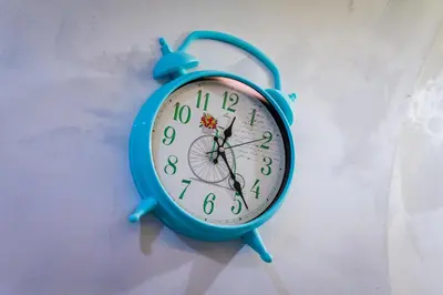 a blue clock hanging on a wall at Sofia Colour Life Apartment -No Window Apartment in Sofia