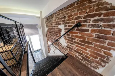 a brick wall with a staircase in a room at Sofia Parter Life Apartment in Sofia