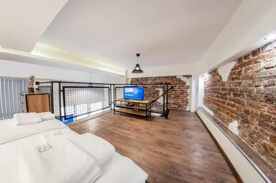 a room with a brick wall and a tv at Sofia Parter Life Apartment in Sofia