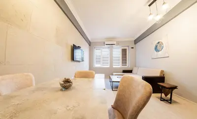 a dining room with a table and chairs and a couch at Sofia Industrial Life Apartment in Sofia